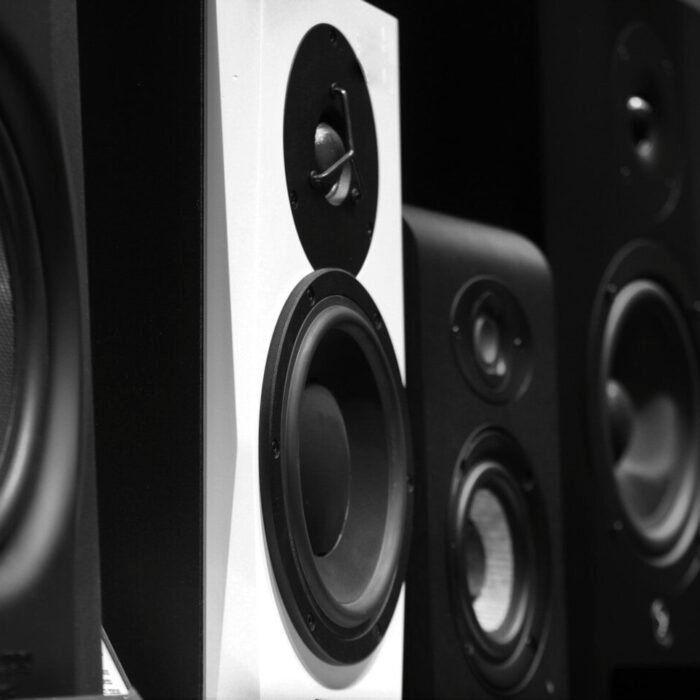 black and gray speakers on brown wooden table
